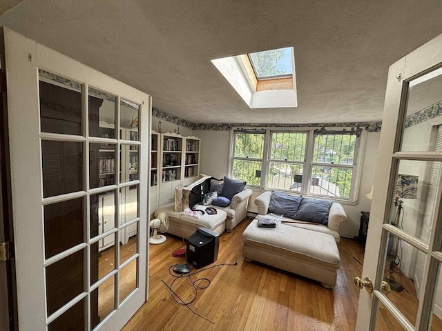 27 Hilton Ter, Boston, MA 02119 - living area with a textured ceiling, a skylight, and hardwood / wood-style floors