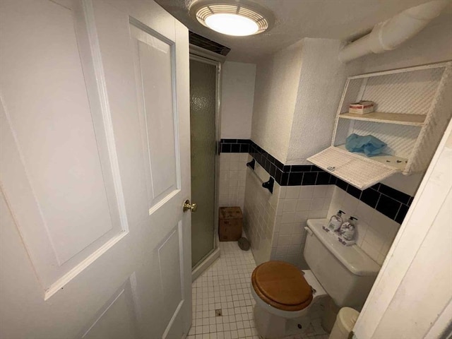 27 Hilton Ter, Boston, MA 02119 - full bathroom with tile patterned floors, a stall shower, tile walls, and a wainscoted wall