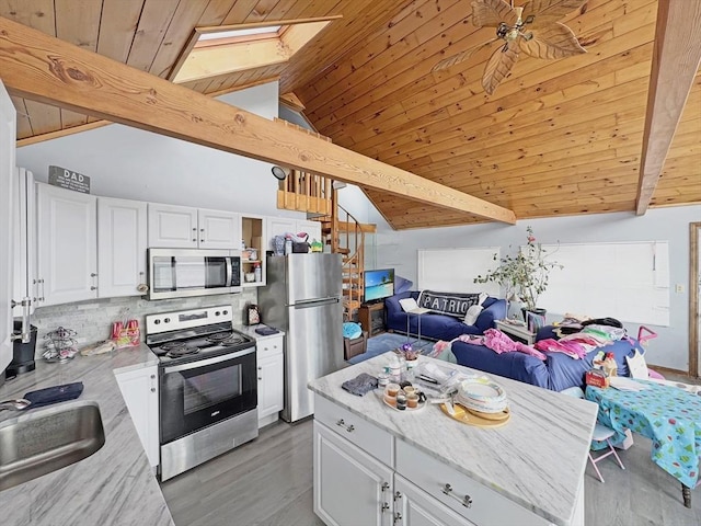 498 N End Blvd, Salisbury, MA 01952 - kitchen featuring appliances with stainless steel finishes, a skylight, wood ceiling, light wood finished floors, and open floor plan