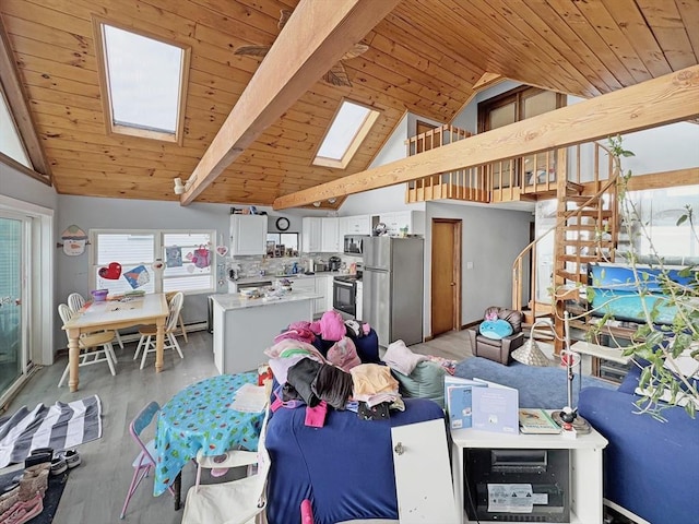 498 N End Blvd, Salisbury, MA 01952 - dining space featuring a skylight, light wood-type flooring, wooden ceiling, plenty of natural light, and high vaulted ceiling