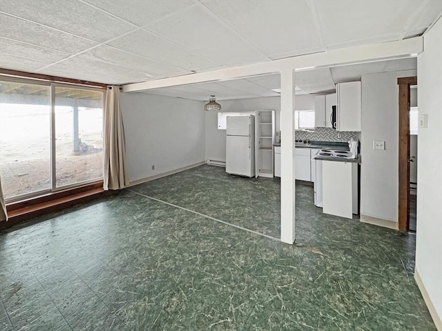 498 N End Blvd, Salisbury, MA 01952 - unfurnished living room featuring dark floors and baseboards