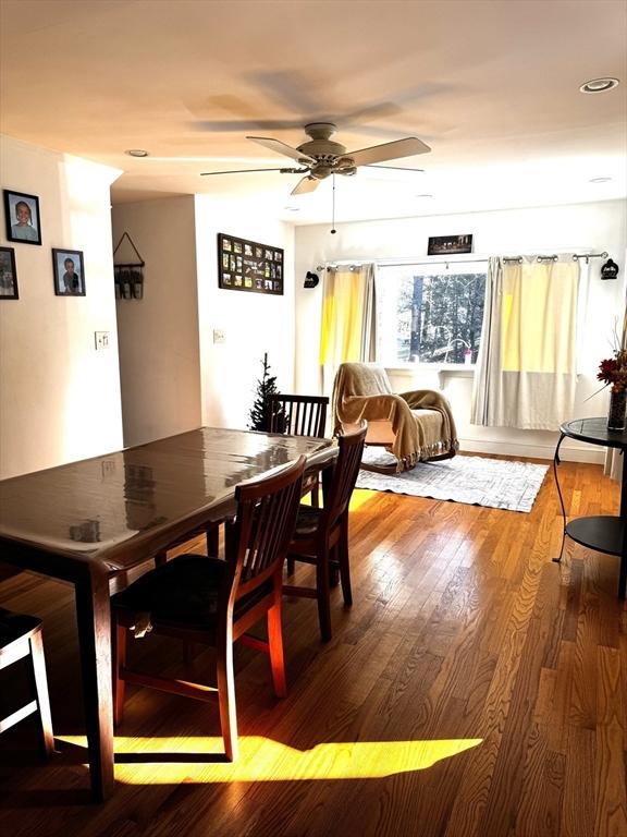 dining area with ceiling fan and hardwood / wood-style flooring