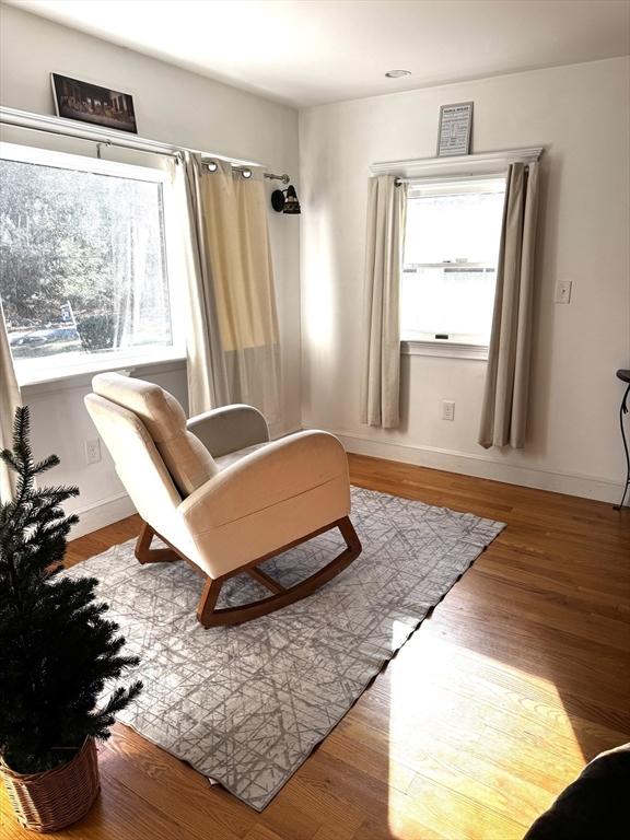 sitting room with wood-type flooring