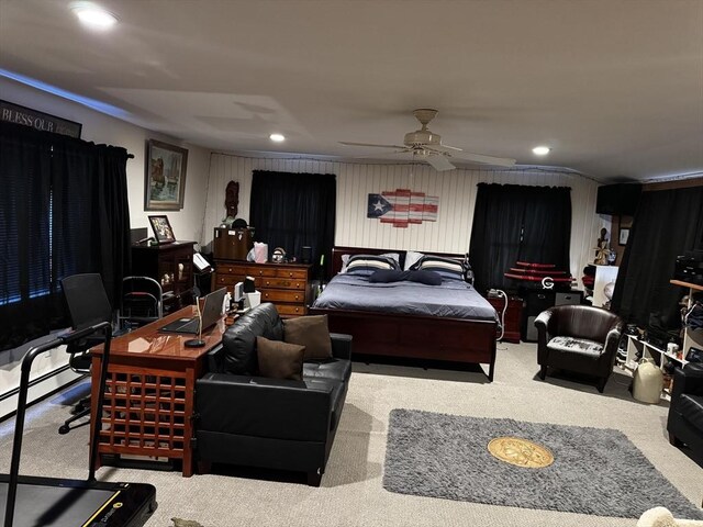 bedroom with ceiling fan, carpet, and a baseboard heating unit