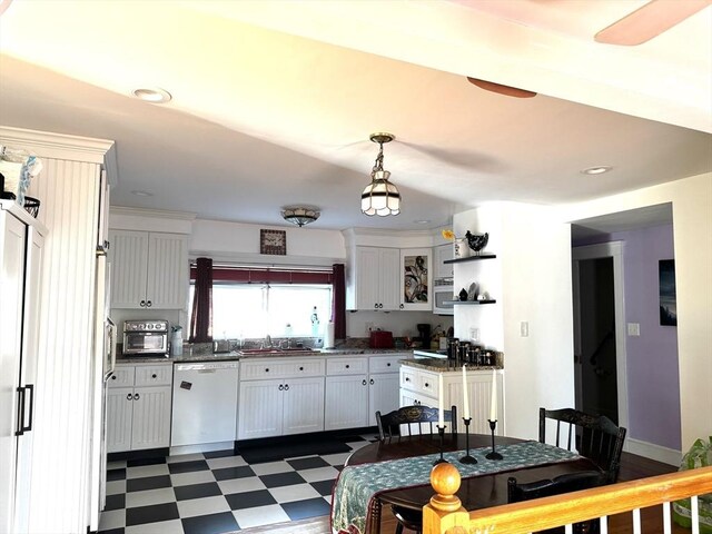 kitchen with dishwasher, white cabinetry, sink, and decorative light fixtures