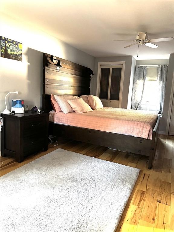 bedroom with ceiling fan and hardwood / wood-style flooring