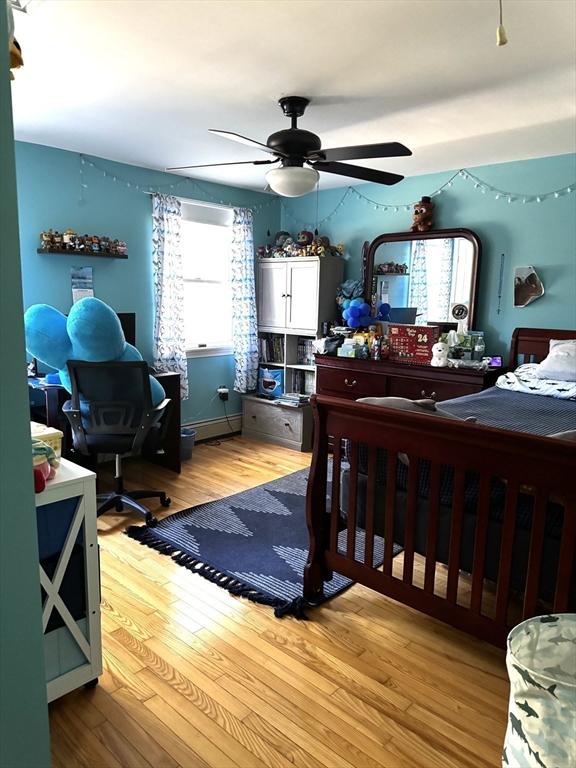 bedroom with ceiling fan and light hardwood / wood-style flooring