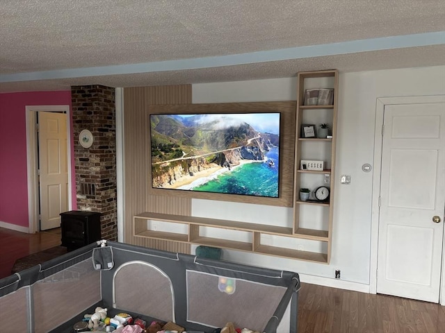 home theater featuring a textured ceiling and dark wood-type flooring