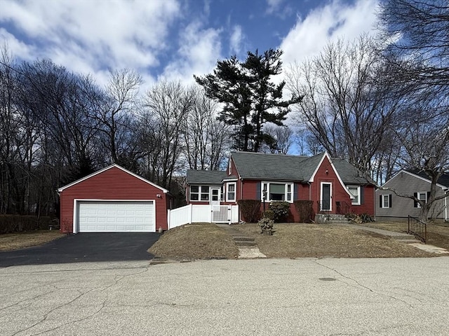 view of front of property with an outdoor structure, fence, and a garage