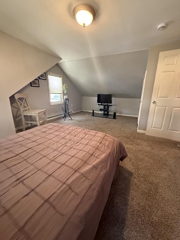 bedroom featuring carpet flooring, baseboards, a baseboard heating unit, and lofted ceiling