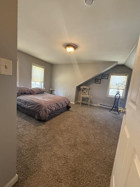 bedroom featuring lofted ceiling, carpet, baseboards, and baseboard heating