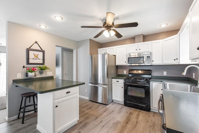 42 Guillotte St, Acushnet, MA 02743 - kitchen featuring stainless steel appliances, a sink, ceiling fan, dark countertops, and recessed lighting