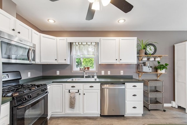 42 Guillotte St, Acushnet, MA 02743 - kitchen with stainless steel appliances, a sink, light wood-type flooring, a ceiling fan, and recessed lighting