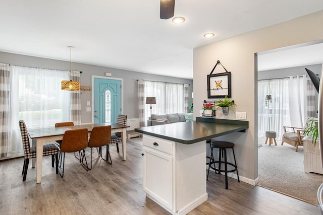 42 Guillotte St, Acushnet, MA 02743 - kitchen featuring dark countertops, a kitchen breakfast bar, healthy amount of natural light, light wood-type flooring, and recessed lighting