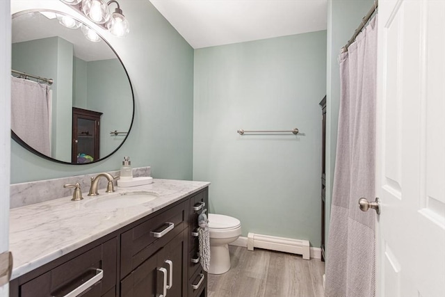 42 Guillotte St, Acushnet, MA 02743 - full bath with a baseboard radiator, wood finished floors, vanity, toilet, and baseboards