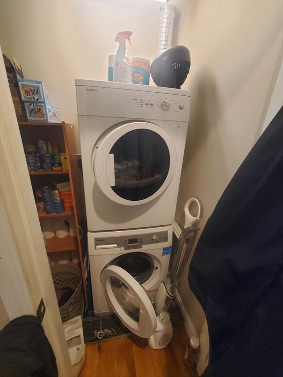 279-279A Dorchester St, Boston, MA 02127 - laundry area featuring stacked washer / drying machine and wood finished floors