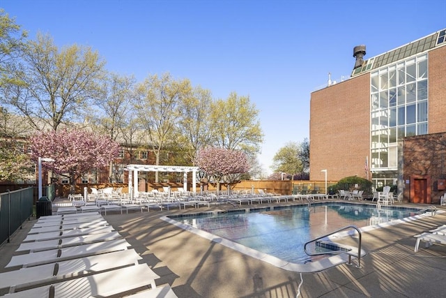 pool with fence, a patio, and a pergola