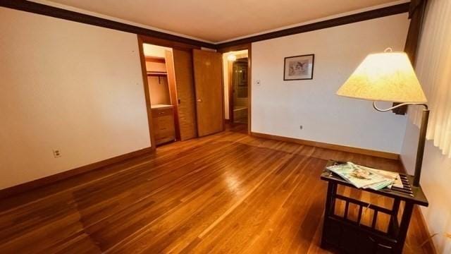 spare room featuring ornamental molding and wood-type flooring