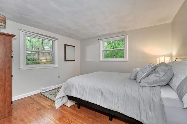 bedroom with wood finished floors and baseboards