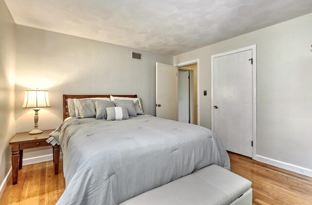 bedroom featuring baseboards and light wood-type flooring