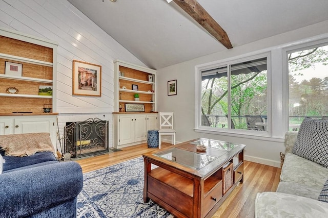 living room with light wood-style floors and a fireplace with flush hearth