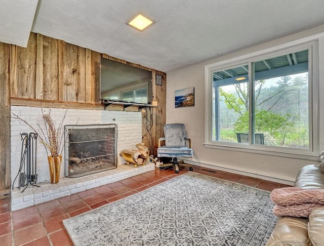 living area with tile patterned flooring and a fireplace