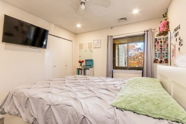 bedroom with ceiling fan and a closet