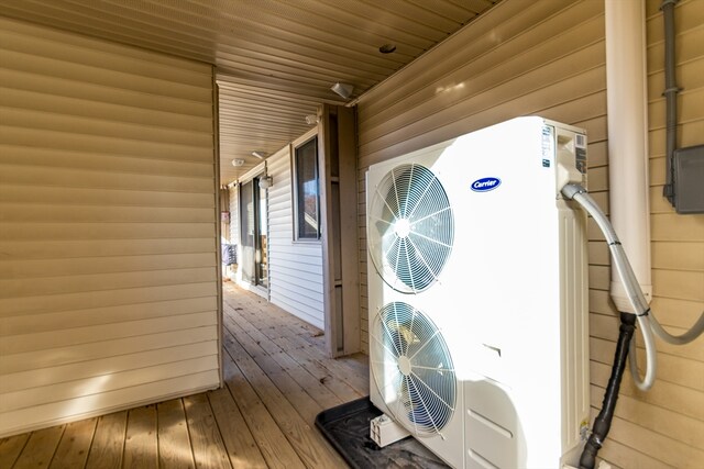 wooden deck featuring ac unit