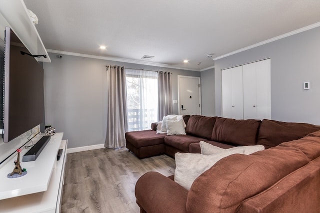 living room with crown molding and light wood-type flooring