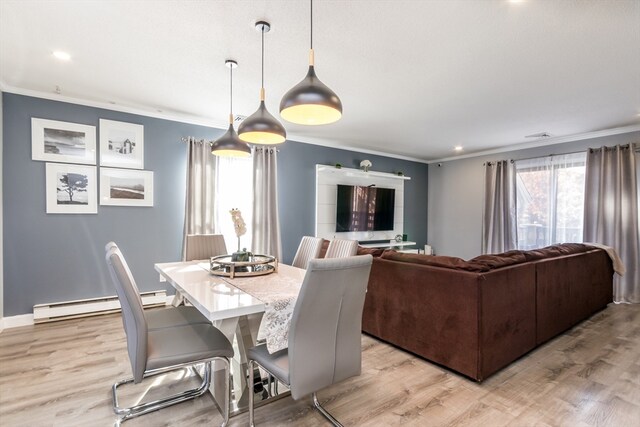 dining area featuring a baseboard heating unit, crown molding, and light hardwood / wood-style flooring