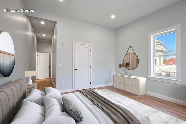 bedroom featuring baseboards, recessed lighting, and wood finished floors