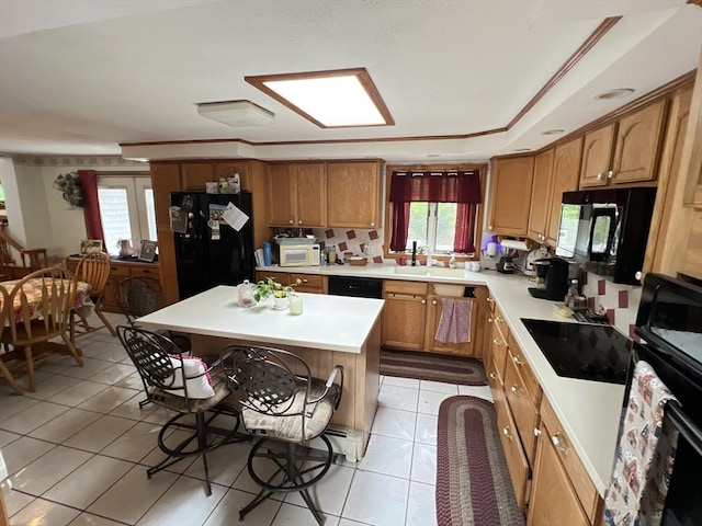19 Wheelhouse Cir, Falmouth, MA 02536 - kitchen with black appliances, light tile patterned floors, light countertops, healthy amount of natural light, and ornamental molding