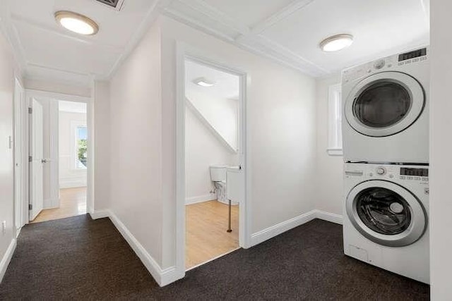 9 Foster St Unit 2, Gloucester, MA 01930 - laundry area with stacked washer / dryer and dark carpet
