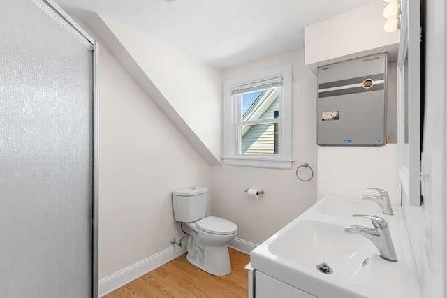 9 Foster St Unit 2, Gloucester, MA 01930 - bathroom featuring wood finished floors and double vanity