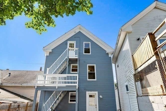 9 Foster St Unit 2, Gloucester, MA 01930 - rear view of property with stairway and a wooden deck