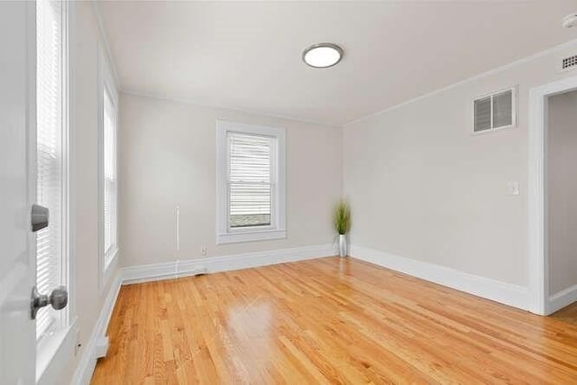 9 Foster St Unit 2, Gloucester, MA 01930 - spare room featuring crown molding and light wood-type flooring