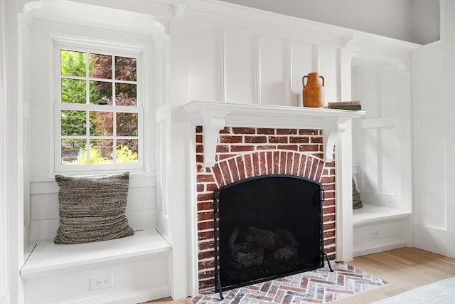 2 Percy Rd, Lexington, MA 02421 - detailed view of wood finished floors, a decorative wall, and a brick fireplace