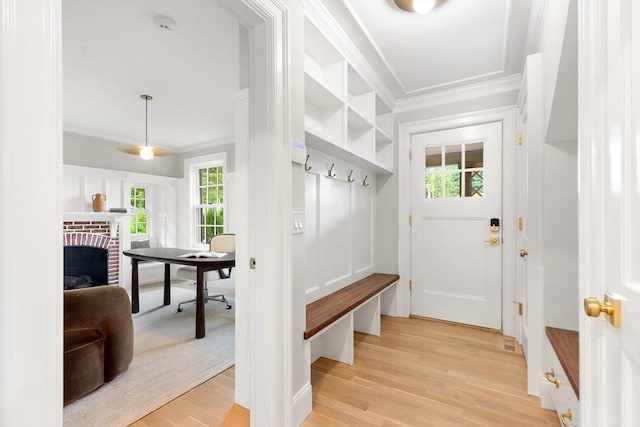 2 Percy Rd, Lexington, MA 02421 - mudroom with crown molding, light wood finished floors, and a fireplace