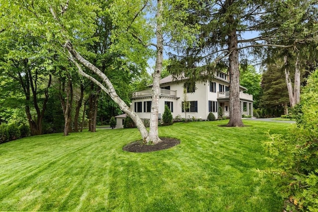 2 Percy Rd, Lexington, MA 02421 - view of front of house with a balcony, stucco siding, and a front lawn