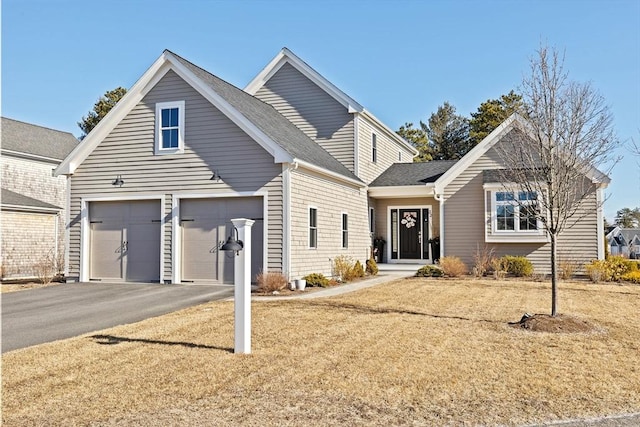 traditional-style home with driveway and a front yard