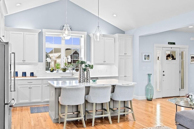 kitchen featuring light countertops, white cabinets, and stainless steel refrigerator