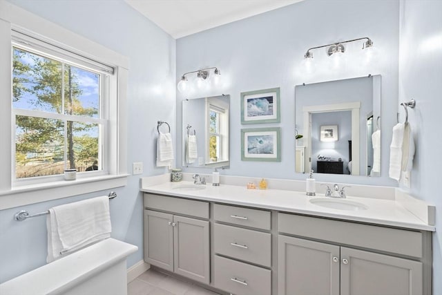 bathroom with double vanity, ensuite bath, and a sink