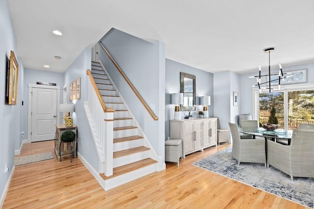 interior space with recessed lighting, an inviting chandelier, baseboards, and wood finished floors