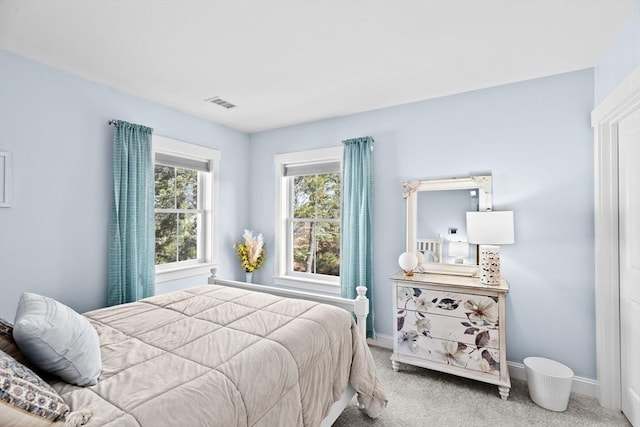 bedroom with carpet, visible vents, and baseboards