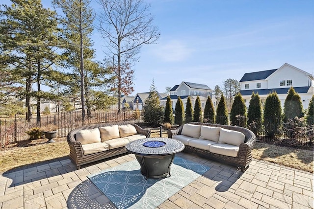 view of patio / terrace featuring an outdoor living space with a fire pit and a fenced backyard