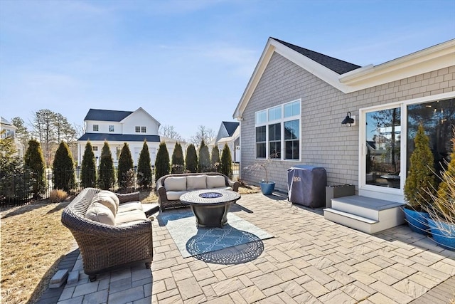 view of patio / terrace with fence, a fire pit, and area for grilling