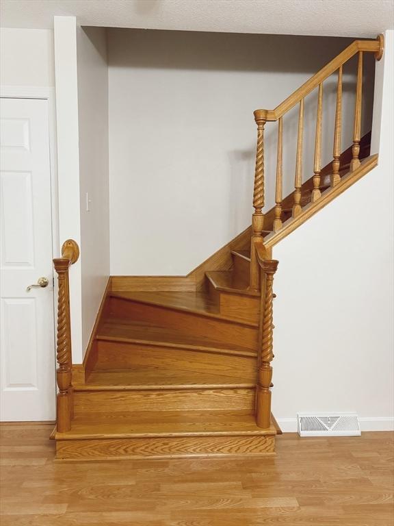 stairway featuring hardwood / wood-style floors