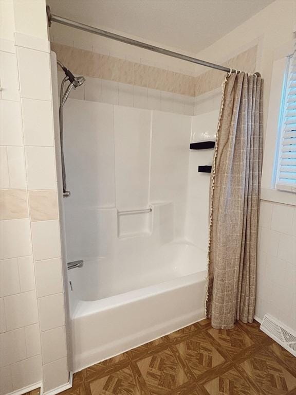 bathroom with shower / bath combo with shower curtain