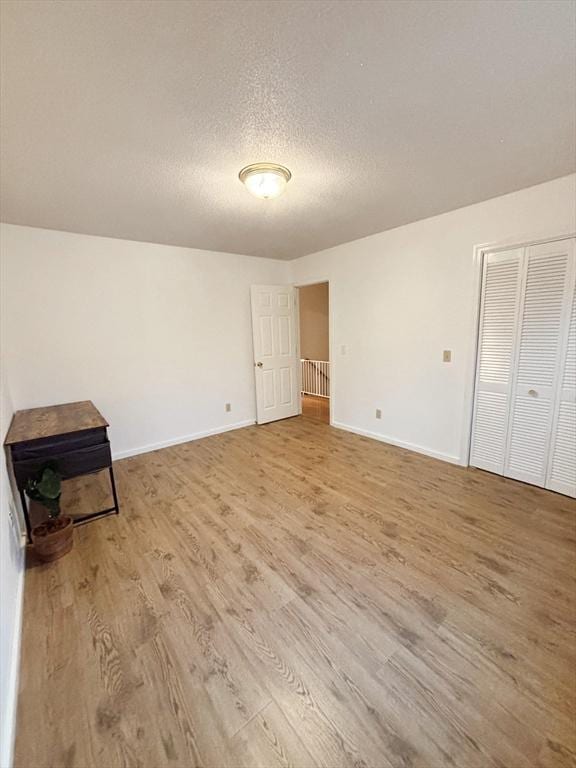 interior space featuring hardwood / wood-style floors and a textured ceiling