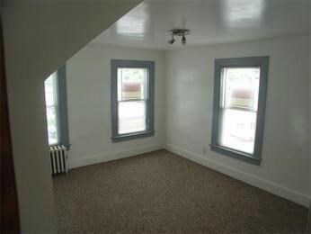 bonus room with radiator and carpet floors